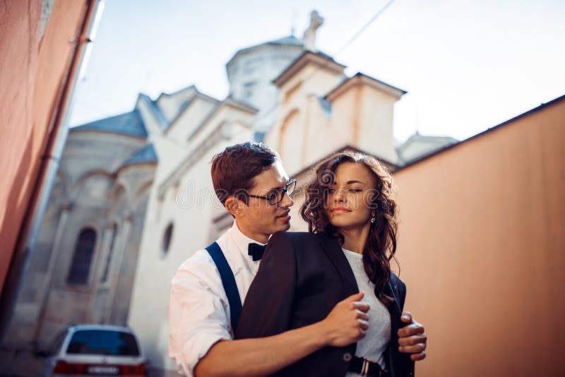 Young couple in love, hugging in the old part of town