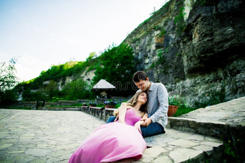 Young couple in love sitting together on a bench in summer park. Happy future, marriage concepts. Vintage royalty free stock photography Young couple in love sitting together on a bench in summer park. Happy future, marriage concepts. Vintage royalty free stock photography