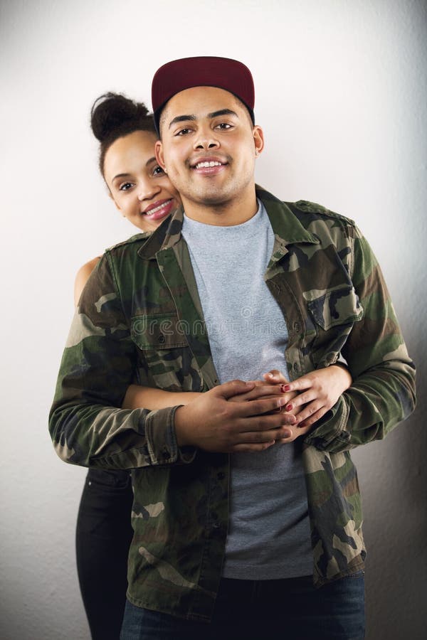 Young couple in love together on grey background stock photography Young couple in love together on grey background stock photography