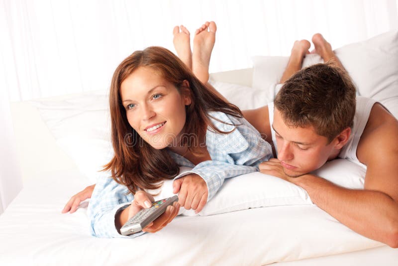 Young Couple Lying Down In Lounge Stock Photo - Image of bedroom