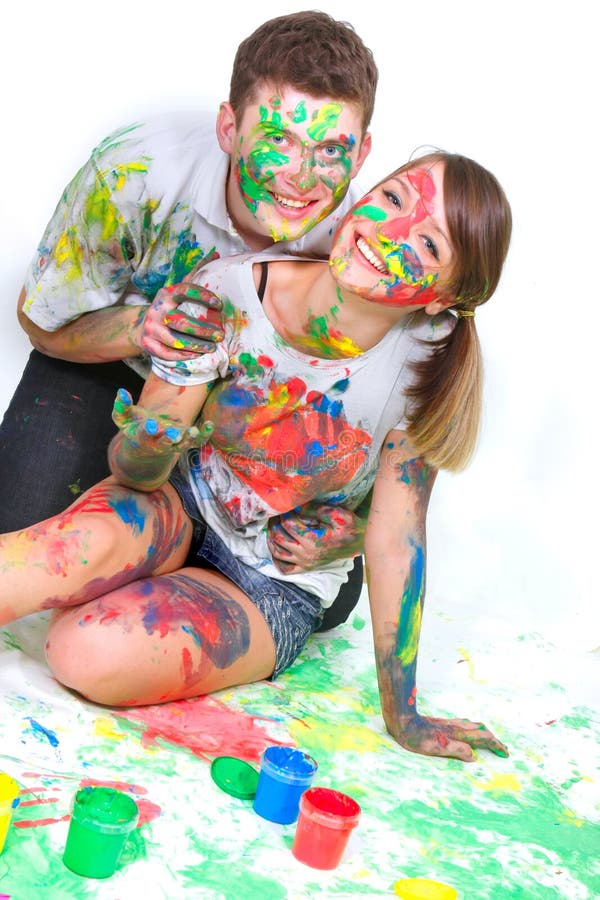 Young couple painting over white