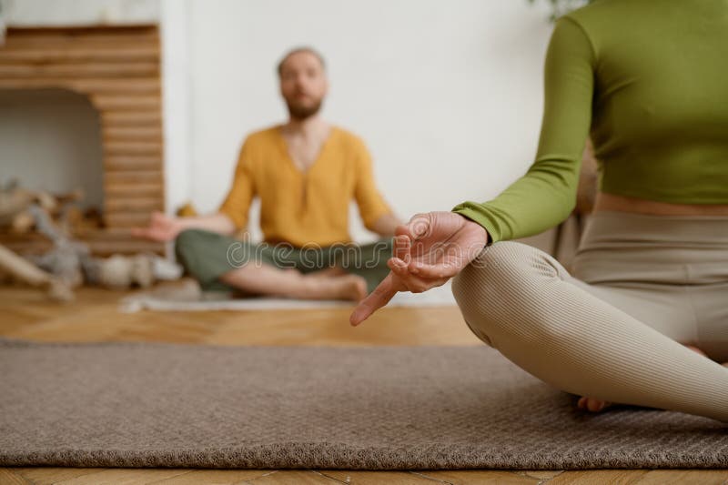Young couple practicing meditation sitting in lotus position stock photos