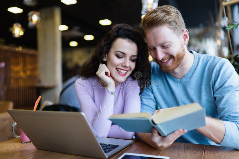 Young Couple Reading Books in Coffee Shop Stock Image - Image of people ...
