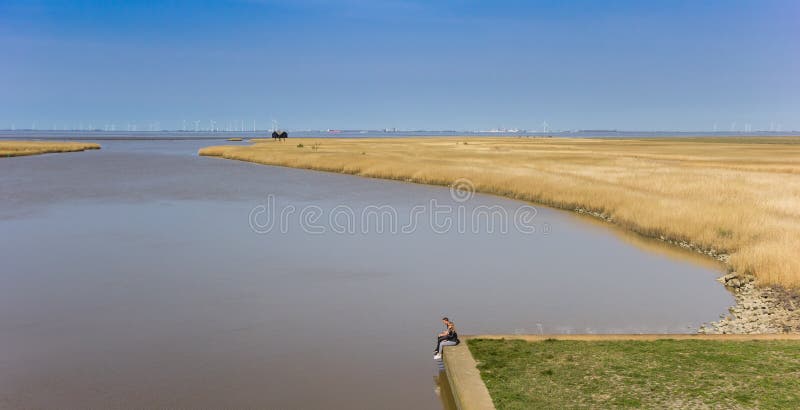 Young couple relaxing at the Dollard bay in Groningen, Holland