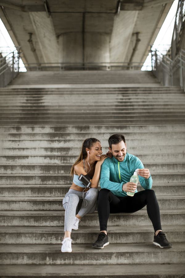 Young couple resting during training with bottle of water stock images