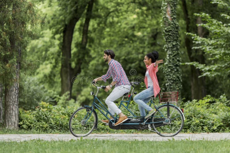 Young Couple Riding on the Tandem Bicycle Stock Photo Image of caucasian, lifestyle 43555646
