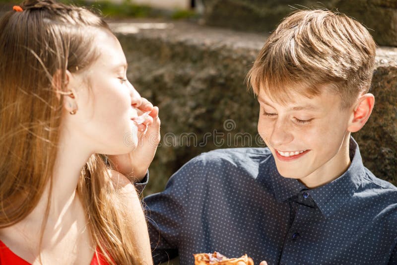 Young Couple On A Romantic Date The Guy Feeds The Girl With A Spoon