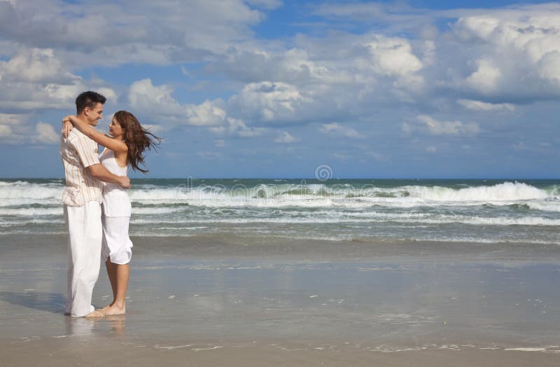 Young Couple In Romantic Embrace On A Beach.