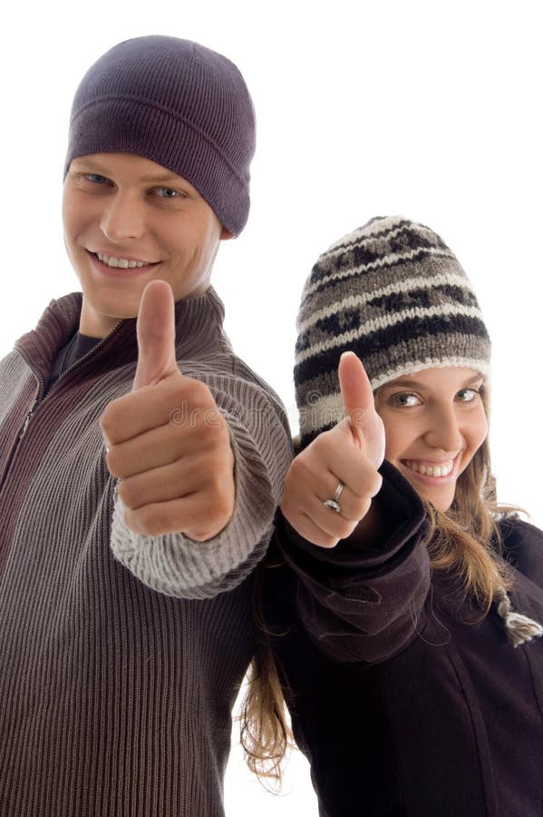 Young couple showing thumbs up