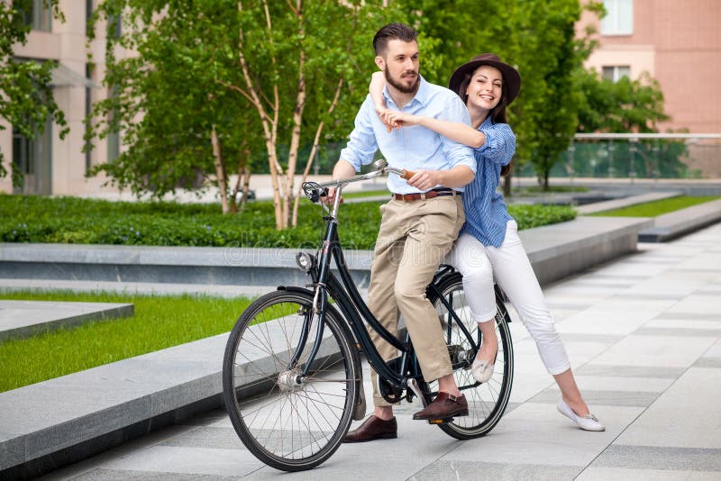 Young Couple Sitting on a Bicycle Stock Photo - Image of cute, casual ...