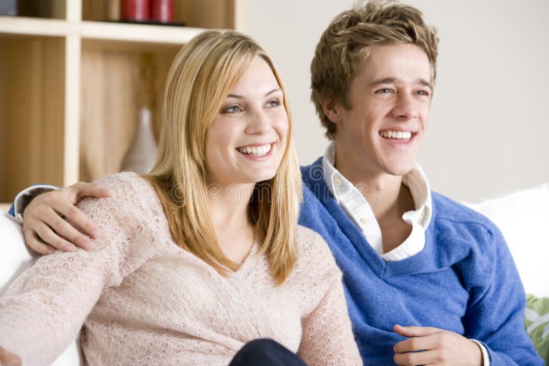 Young couple watching tv on sofa