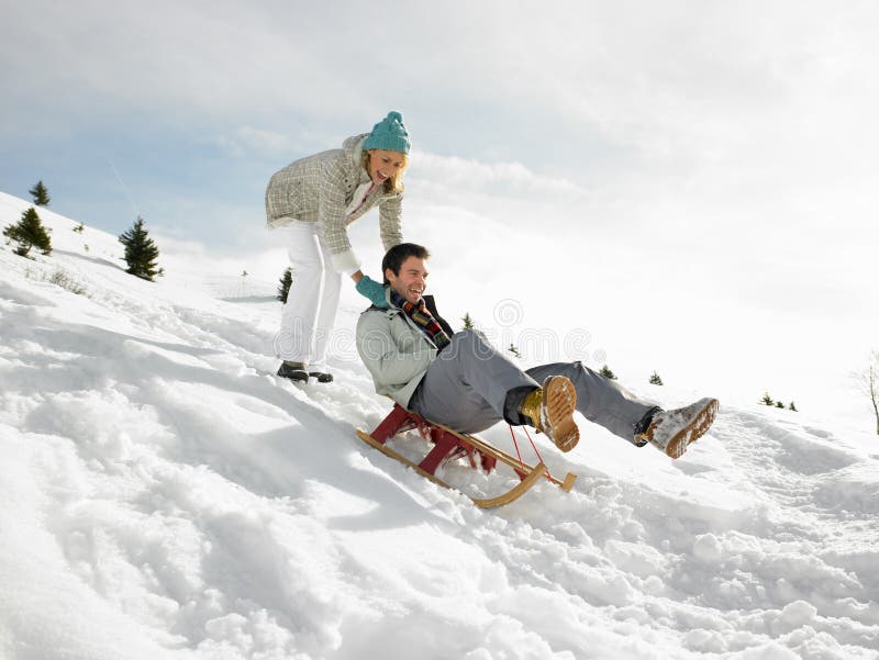 Young Couple Sledding royalty free stock photography Young Couple Sledding royalty free stock photography