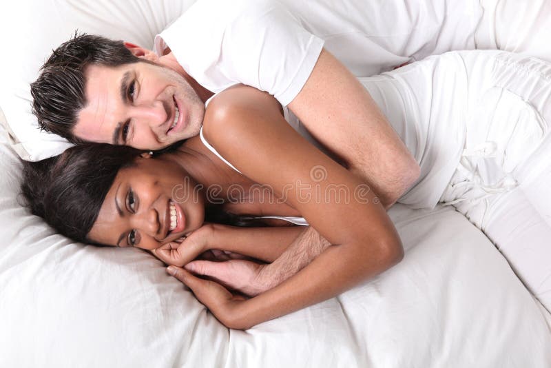Young couple smiling in bed