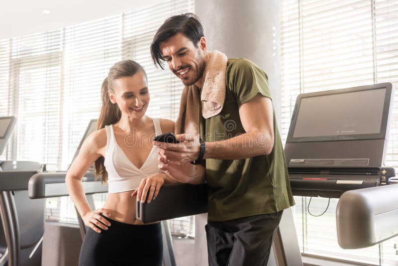 Young couple smiling while communicating on the mobile phone dur stock photos Young couple smiling while communicating on the mobile phone dur stock photos