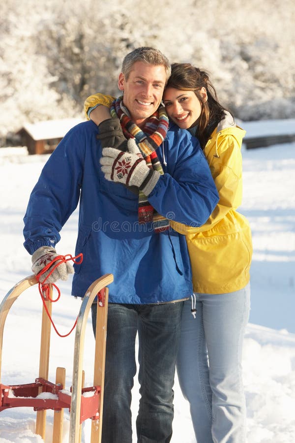 Young Couple Standing In Snowy Landscape