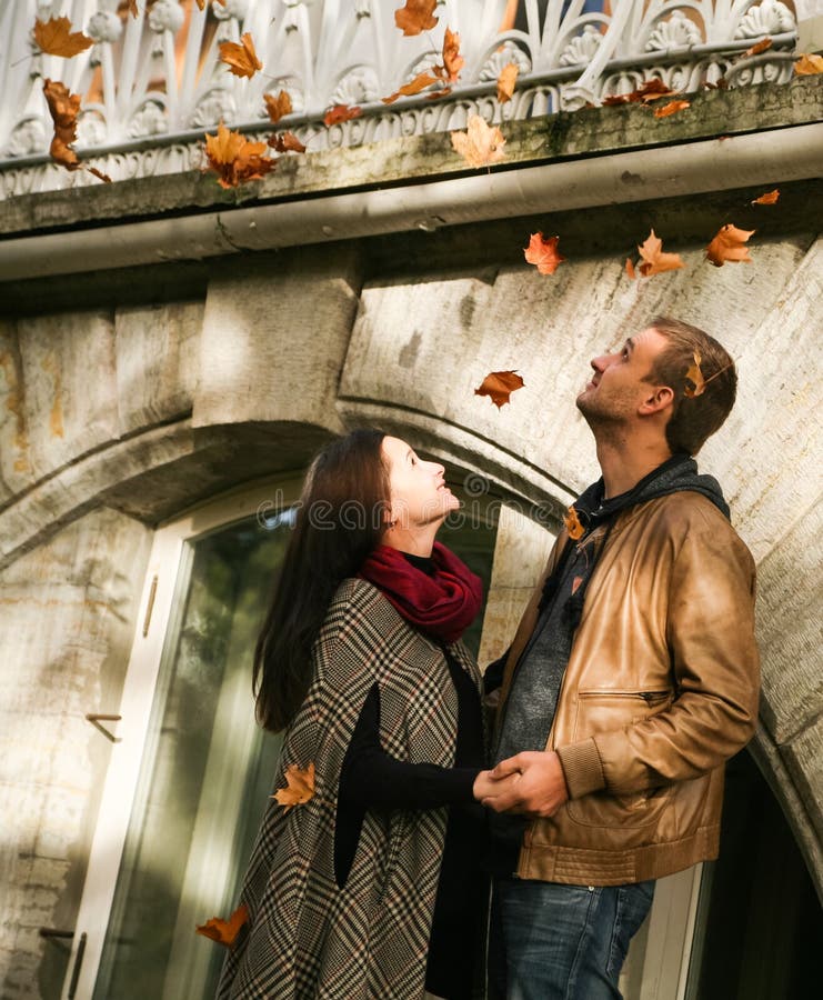 Young couple standing under leaf fall royalty free stock photos