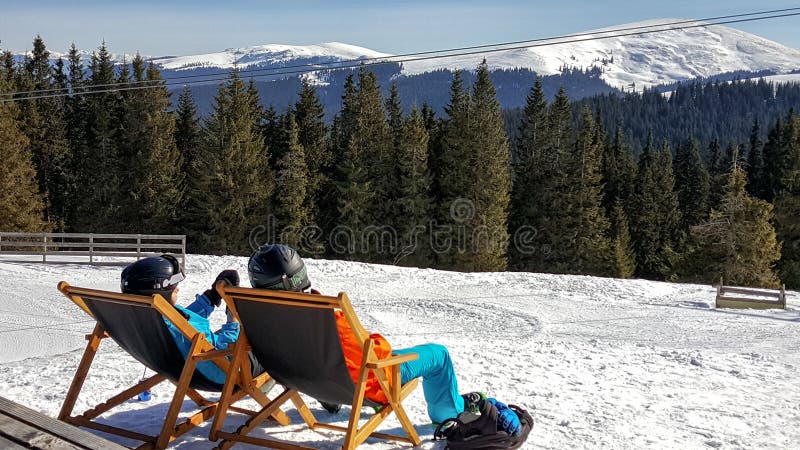 Young couple sunbathing at a ski resort