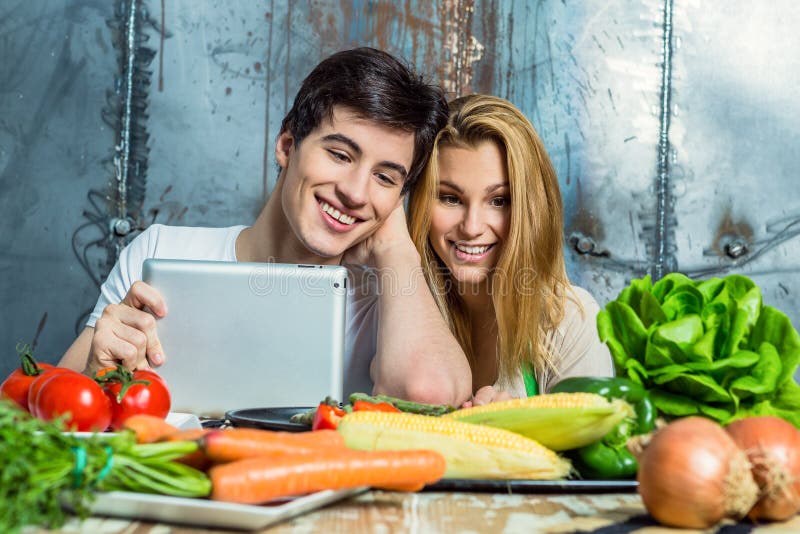 Young Couple Surfing the Web in the Kitchen