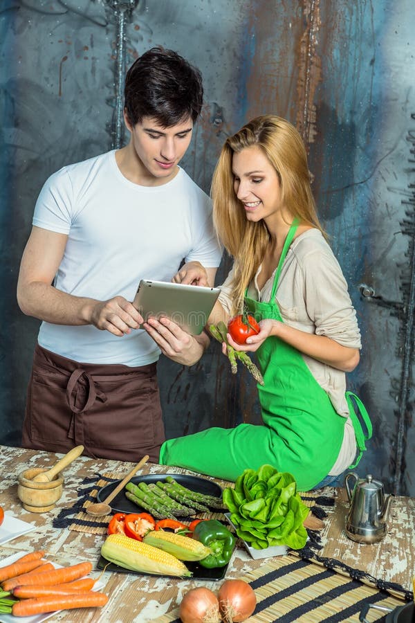 Young Couple Surfing the Web in the Kitchen