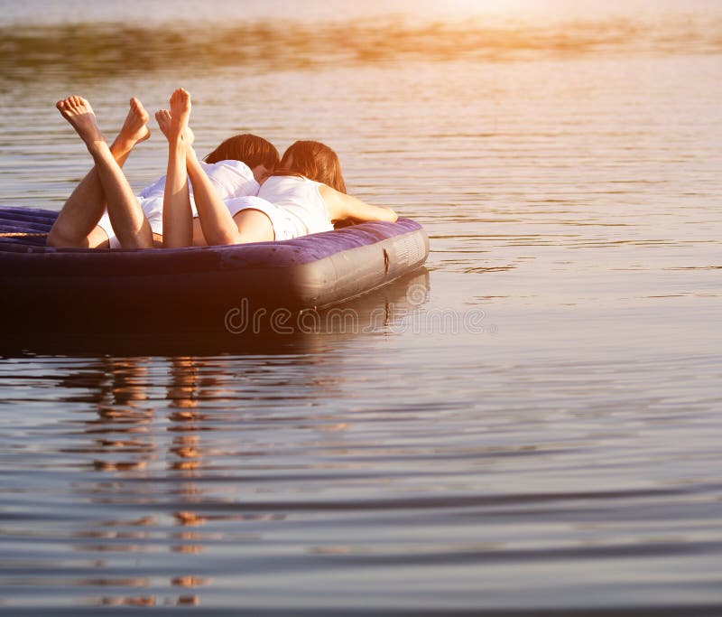 Young couple on the swimming mattress stock image Young couple on the swimming mattress stock image