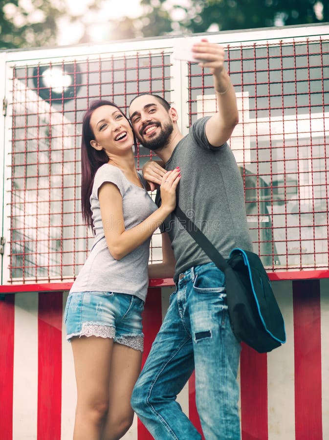 Joyful Young Loving Couple Making Selfie On Camera While Standing