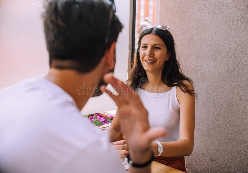 Young couple talking in coffee shop