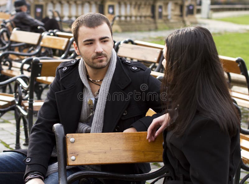 Young couple talking in park stock image