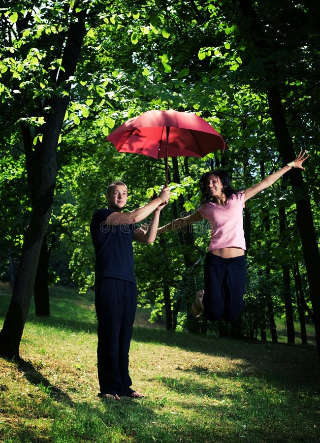 Young couple under umbrella.