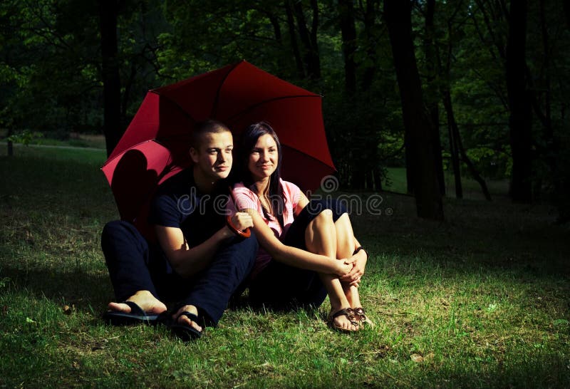 Young couple under umbrella.