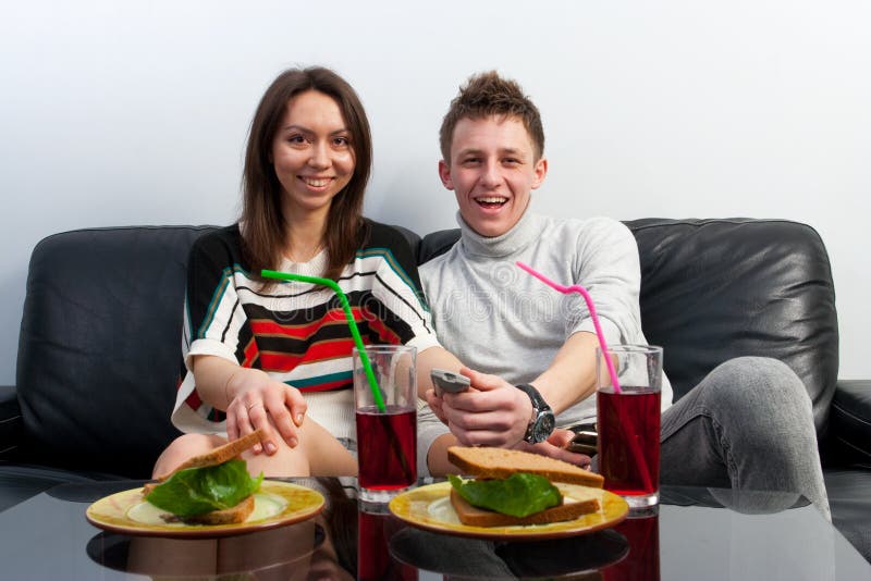 The young couple watches TV