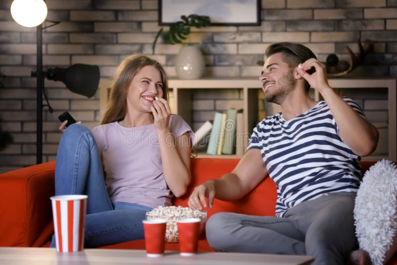Young Couple Watching TV on Sofa at Night Stock Image Image of watch
