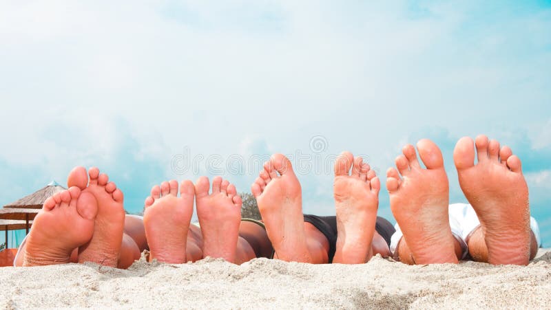 Young couples feet at the beach stock photography