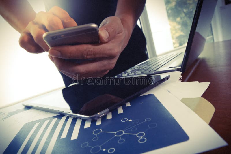 Young creative designer man working at office and smartphone as concept