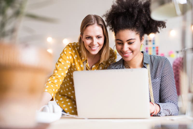 Young creative women with laptop in studio, startup business.