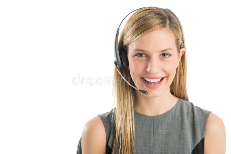 Close-up portrait young female customer service representative wearing headset smiling against white background. Close-up portrait young female customer service representative wearing headset smiling against white background