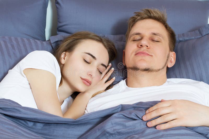 Young Cute Couple Sleeping Together in Bed. Comfortable Bed and