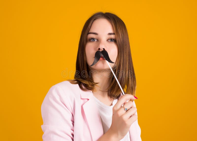 Young cute girl with moustache, studio. 