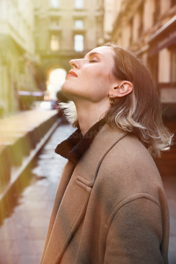 Young beautiful woman enjoying nice city walk. Vertical image.