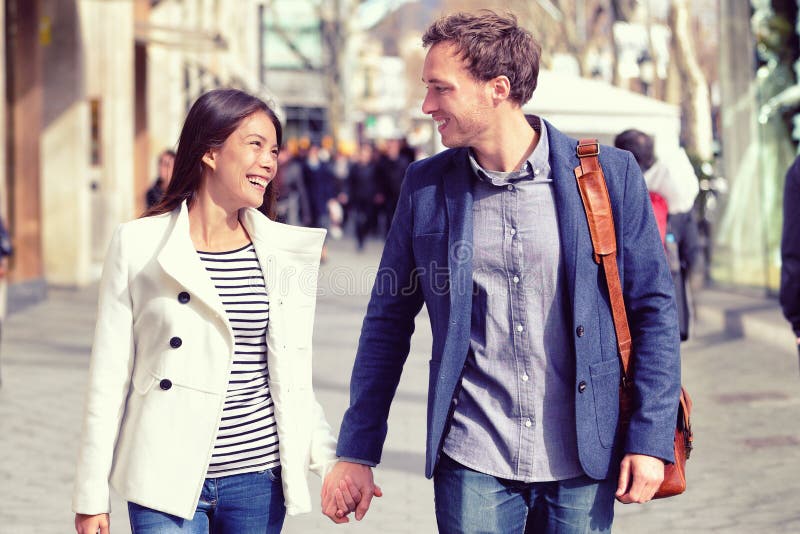 Young dating couple flirting walking in city