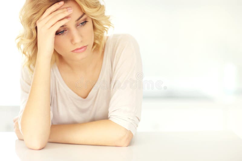 Young depressed woman at home