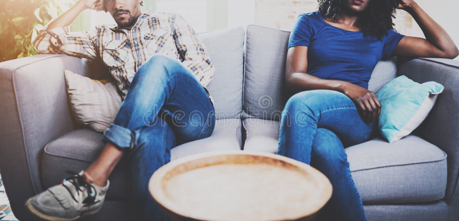 Young displeased black couple.American african men arguing with his girlfriend,who is sitting on sofa on couch next to stock images Young displeased black couple.American african men arguing with his girlfriend,who is sitting on sofa on couch next to stock images