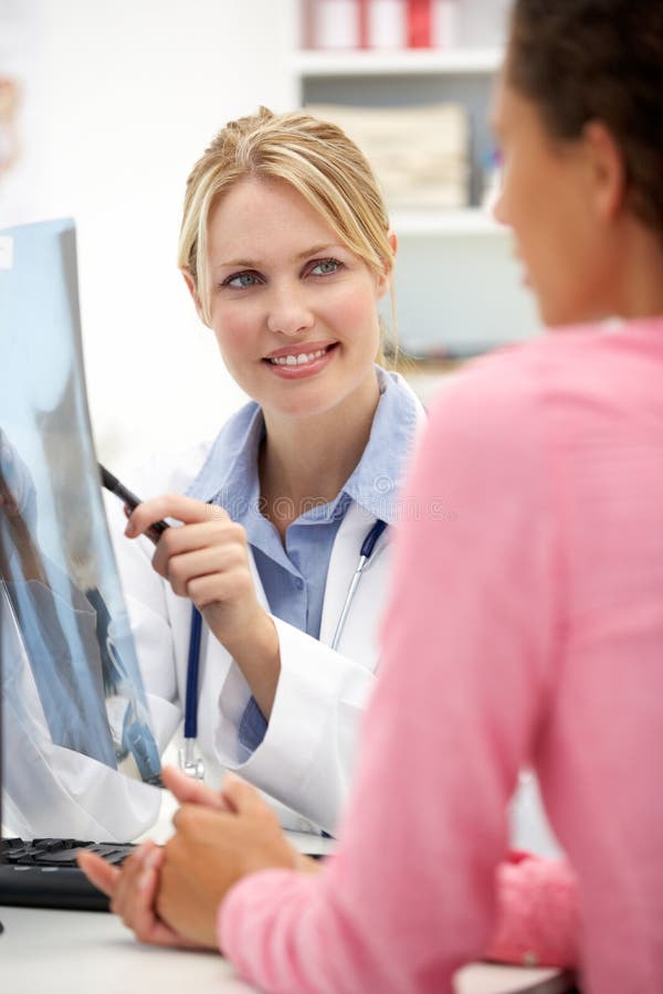 Young doctor with female patient stock photo