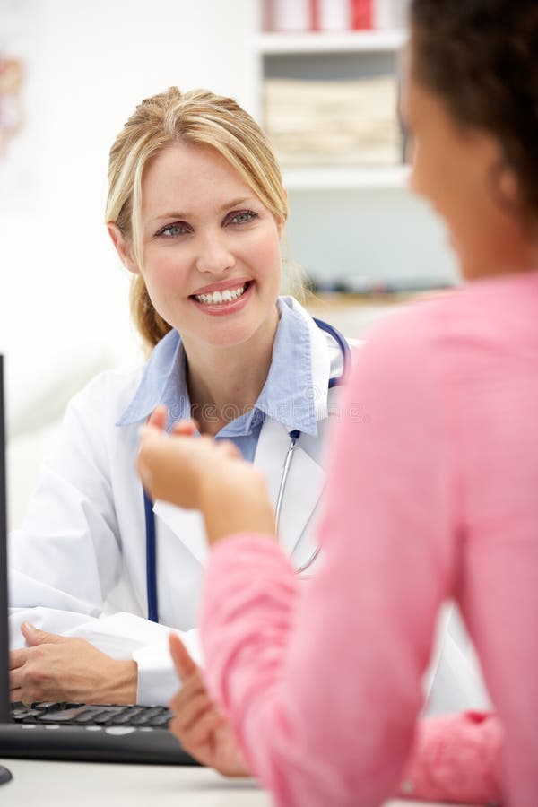 Young doctor with female patient royalty free stock photography