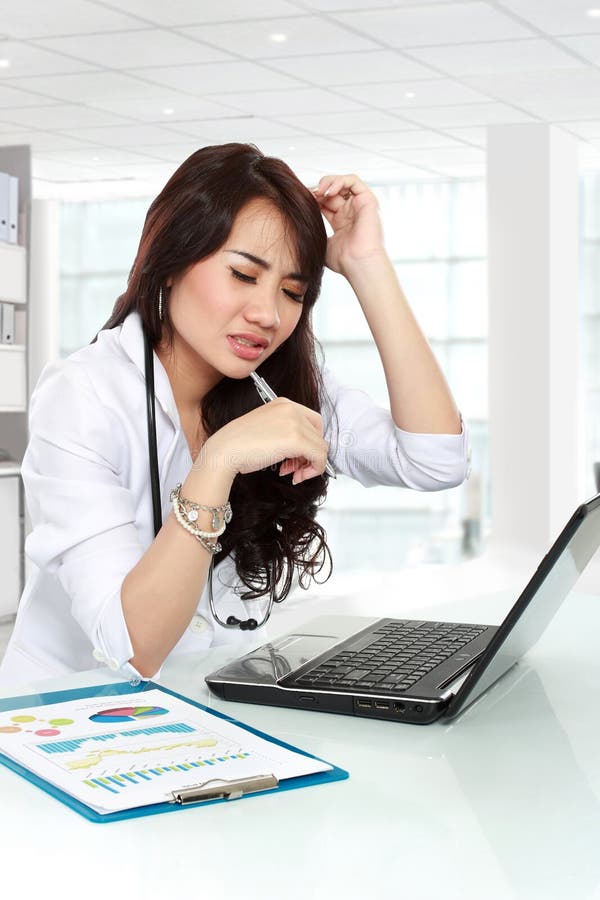 Young doctor having headache royalty free stock photography