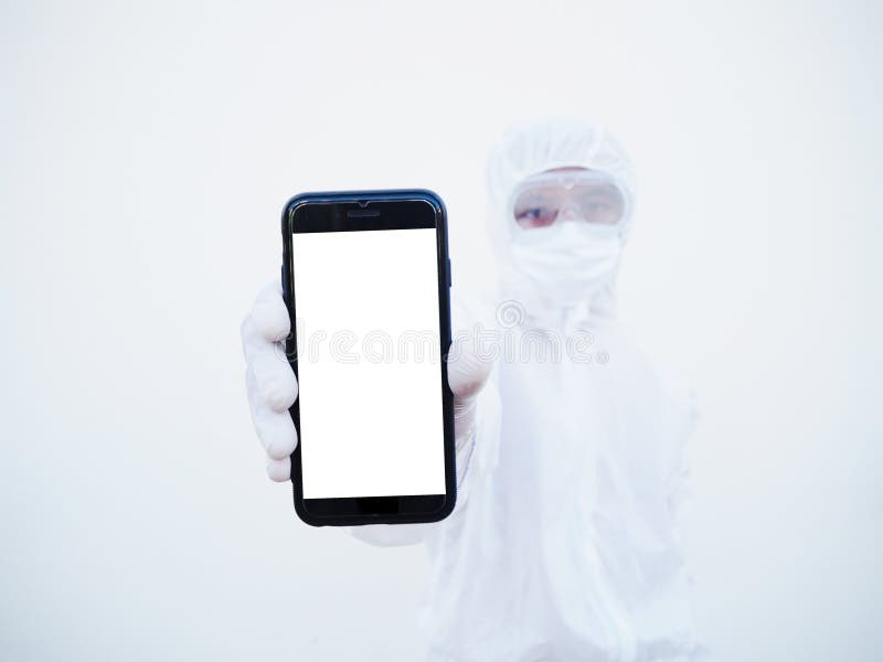Young doctor or scientist in PPE suite uniform holding a smart phone with blank white screen for text or design. coronavirus or royalty free stock photos