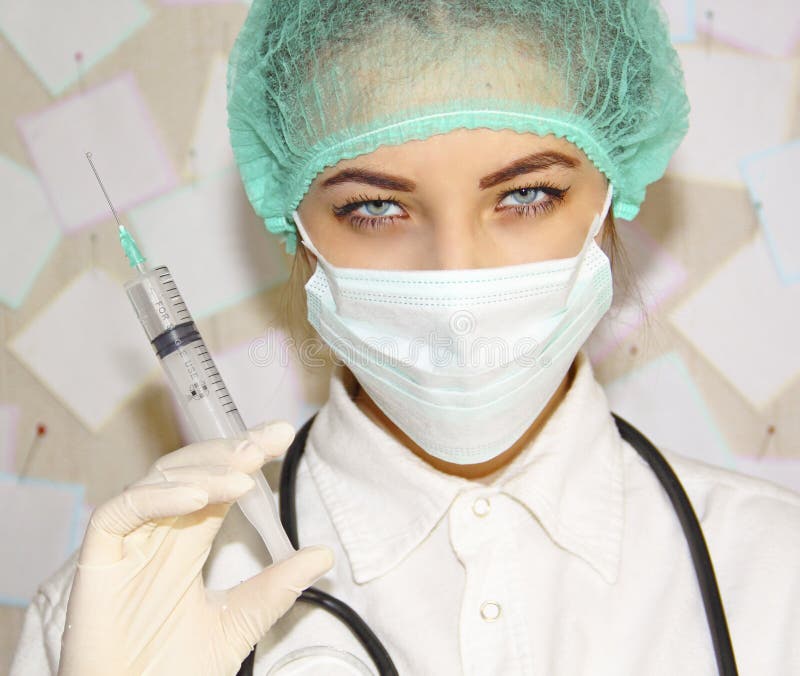 Young doctor with a syringe preparing to inject