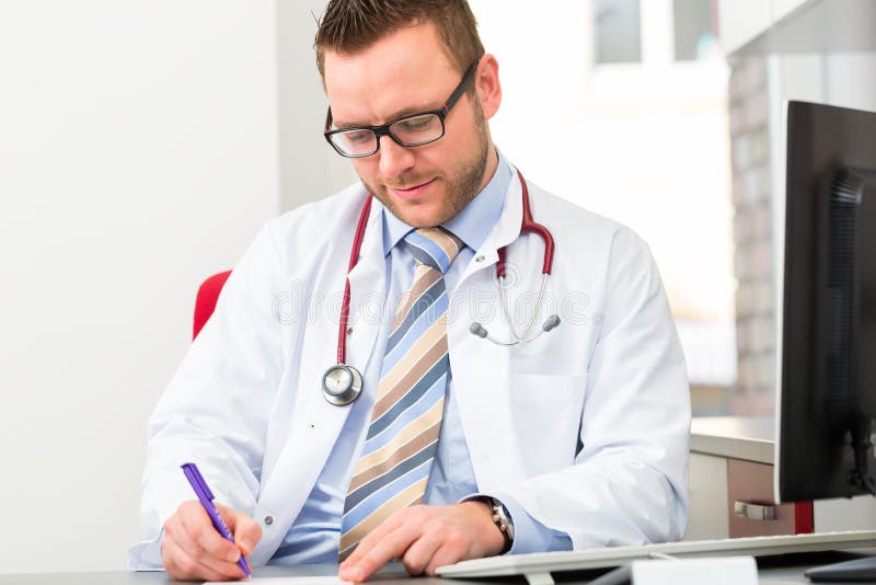 Young doctor writing medical prescription