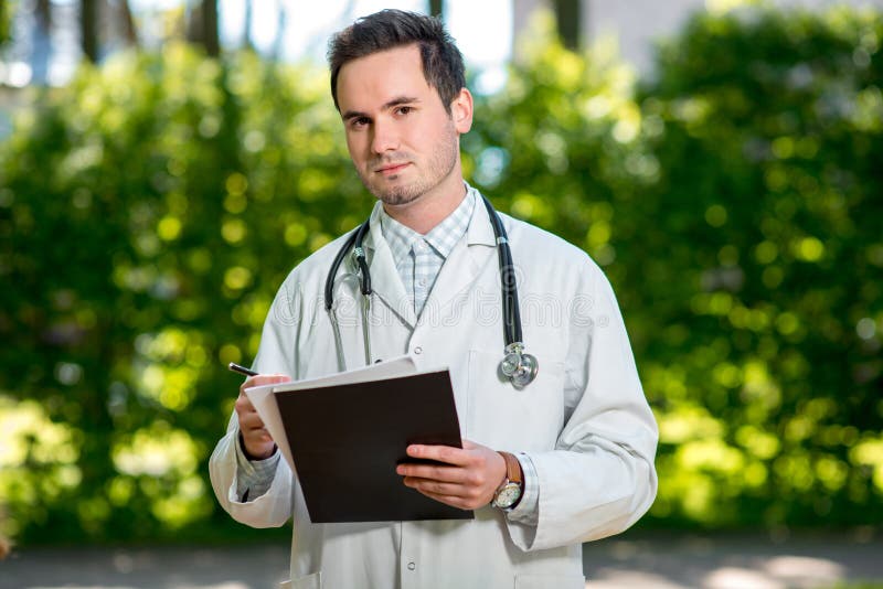 Young doctor writing recipe