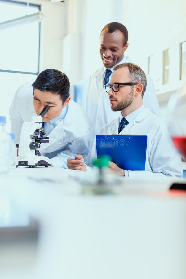 Young Doctors in Uniform Working at Testing Laboratory Stock Image