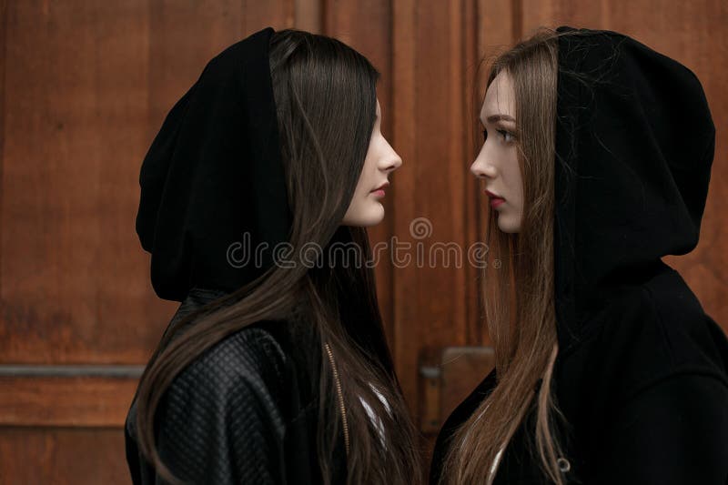 Young elegant trendy girls outdoors, wearing black and white clothing stock image Young elegant trendy girls outdoors, wearing black and white clothing stock image